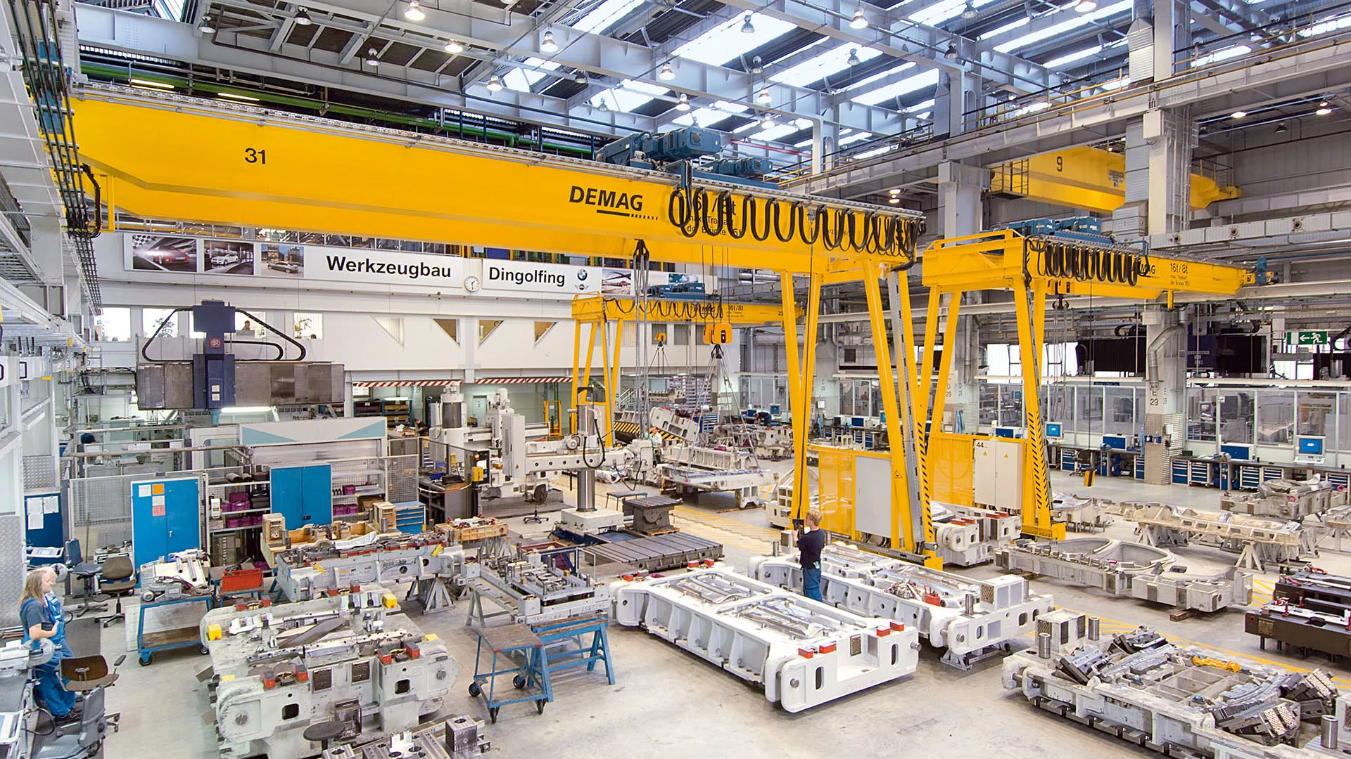 Warehouse DEMAG crane and hoist systems, highlighting 7 Features to Look for in such equipment within a manufacturing environment.