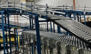 A complex network of blue and grey conveyors in a warehouse highlights how automation reduces fulfillment errors.