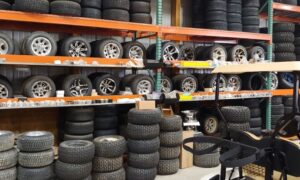 A warehouse section with shelves full of tires and wheels, showing how optimized storage maximizes inventory capacity