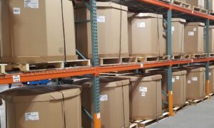 Palletized cartons on warehouse shelving arranged for clear labeling and easy access.