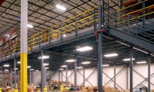 Warehouse mezzanine with overhead lighting and electrical systems integrated for workspace efficiency