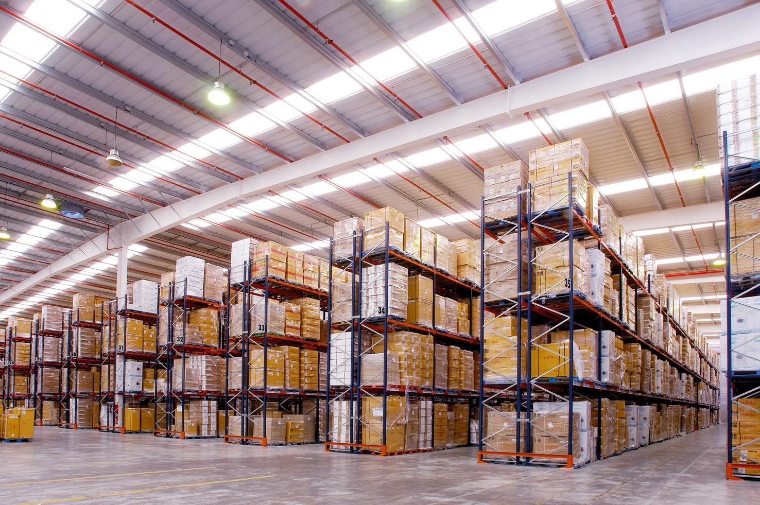 Warehouse Bright, spacious mini warehouse interior with rows of shelving units filled with storage boxes. Features of mini warehouse storage units.