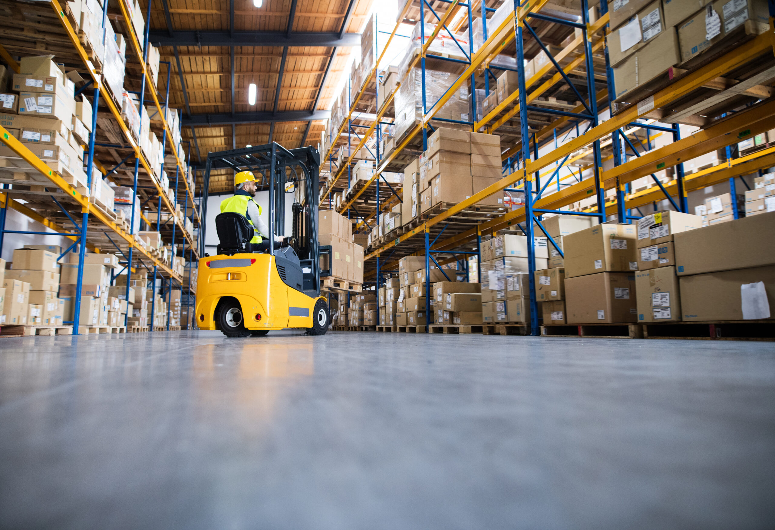 Warehouse Forklift in a well-organized warehouse, illustrating Achieving Operational Excellence Through effective Warehouse Racking Installation.